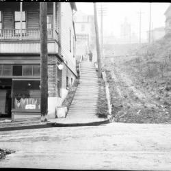 At intersection of south curb line of Main St. and west curb line of Maynard Ave. looking north along the west curb line of Maynard Ave.  Target on level rod held by Chauncy Wernecke is set at 0.75'